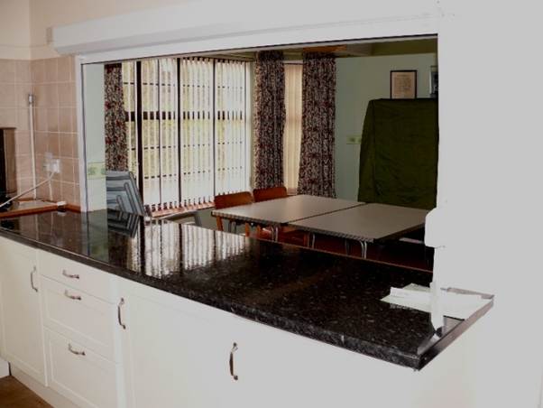 A kitchen with a black counter top
AI-generated content may be incorrect.